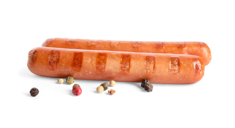 Photo of Tasty grilled sausages and peppercorns on white background