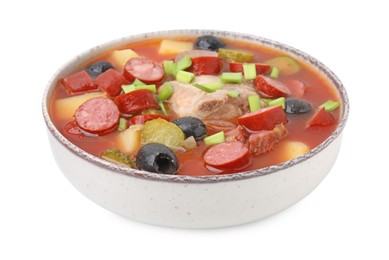 Meat solyanka soup with thin dry smoked sausages in bowl isolated on white