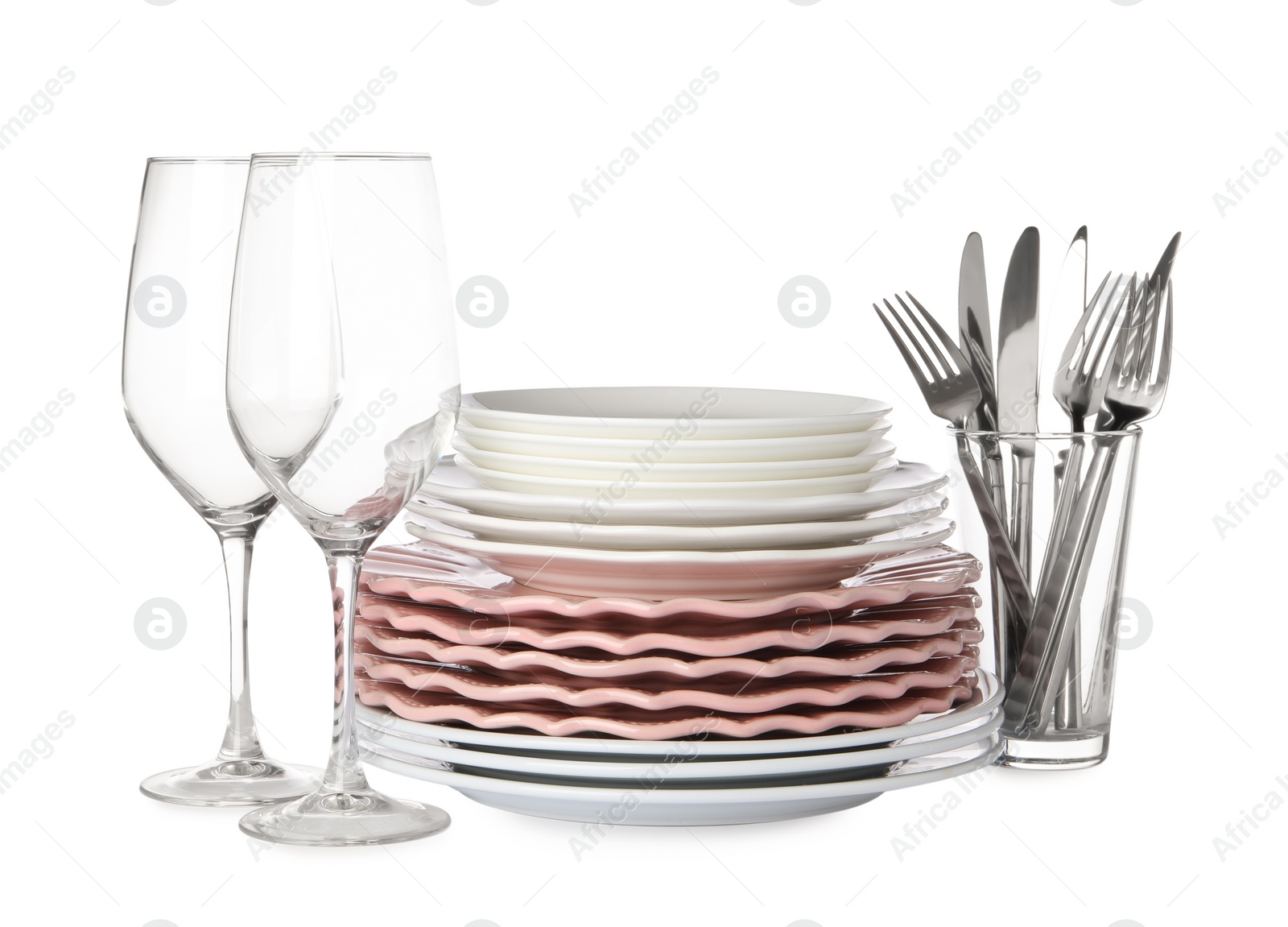 Photo of Set of beautiful ceramic plates, glasses and cutlery isolated on white