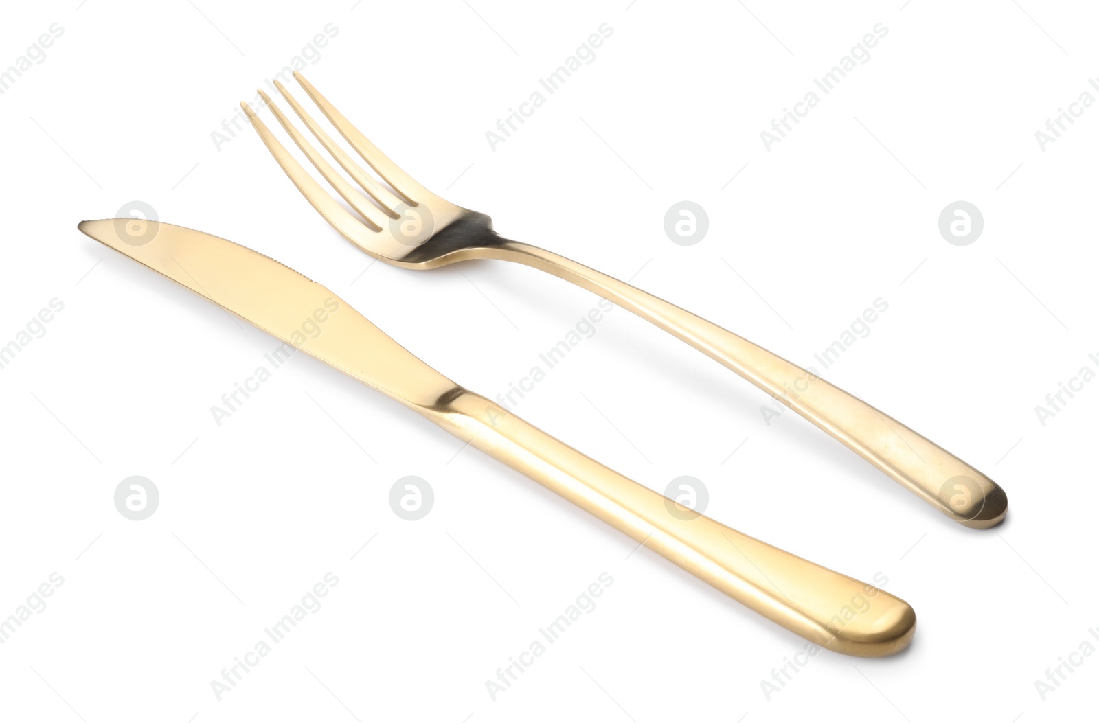 Photo of Shiny golden fork and knife isolated on white. Luxury cutlery