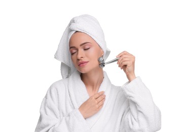 Photo of Young woman massaging her face with metal roller isolated on white