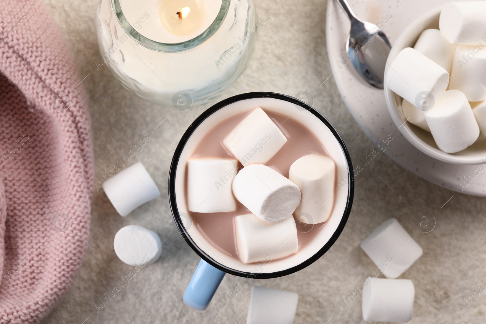 Photo of Cup of aromatic hot chocolate with marshmallows served on beige table, flat lay