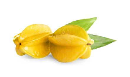 Ripe carambolas with green leaves on white background