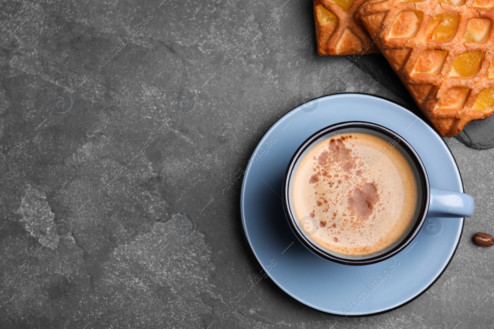 Photo of Delicious coffee and pastries on grey table, flat lay. Space for text