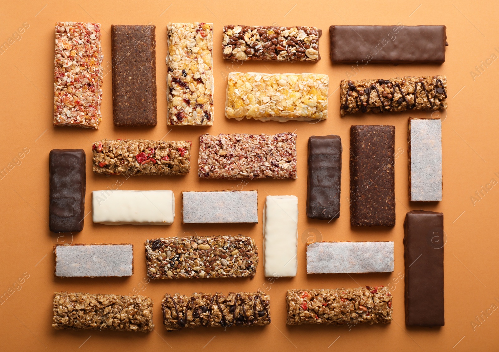 Photo of Flat lay composition with protein bars on color background