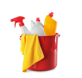 Photo of Plastic bucket with different cleaning products and rag on white background