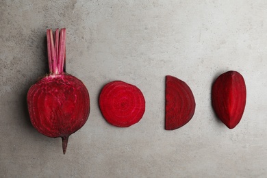 Flat lay composition with raw beets on grey background