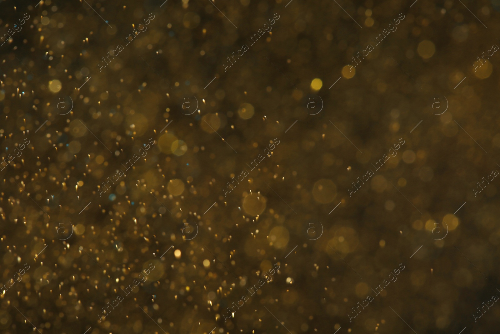 Photo of Magic golden bokeh effect on color background