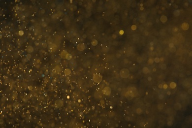 Photo of Magic golden bokeh effect on color background
