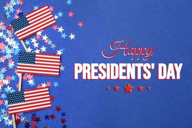 Image of Happy President's Day - federal holiday. American flags, star shaped confetti and text on blue background, flat lay