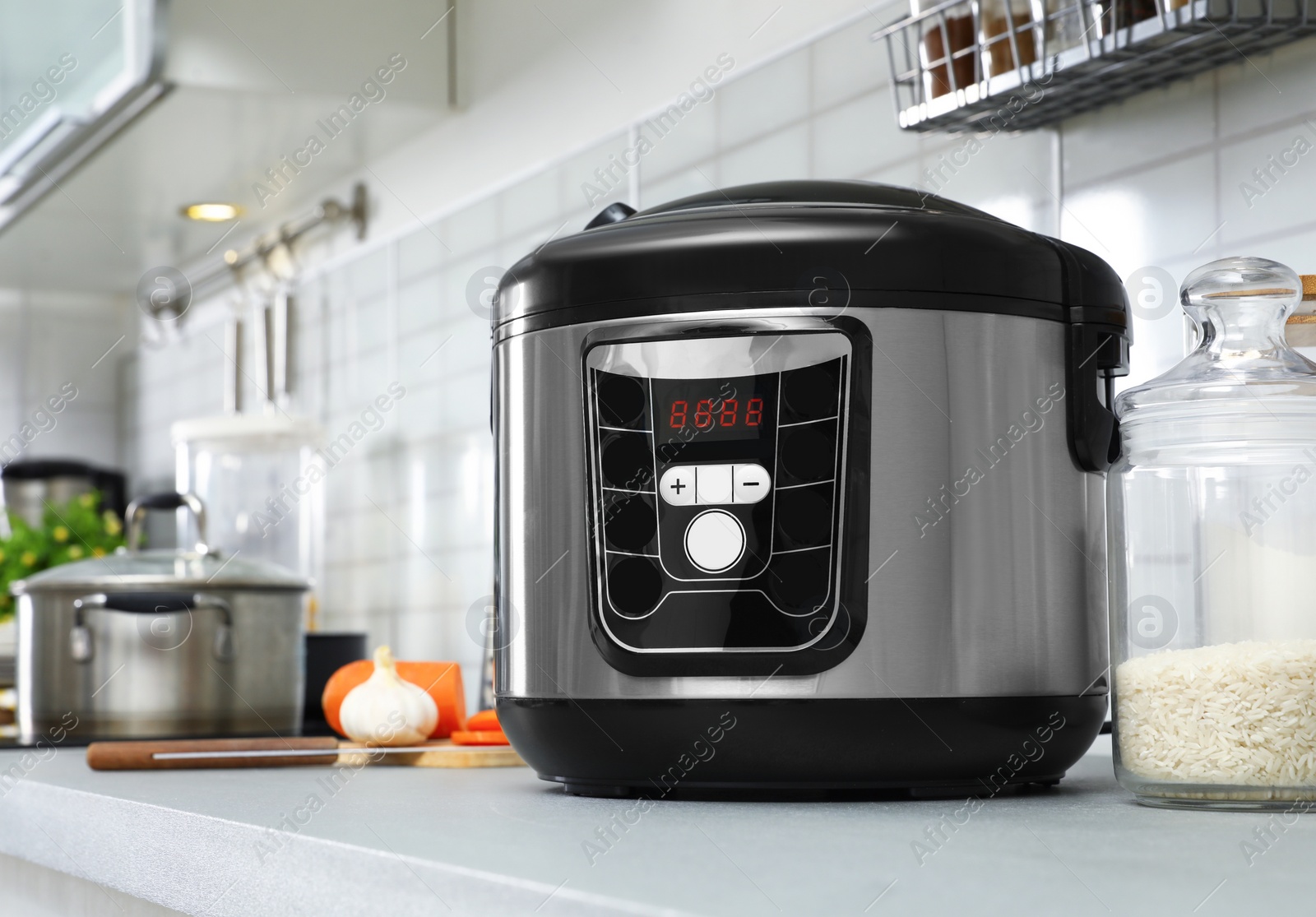 Photo of Modern multi cooker on table in kitchen. Space for text