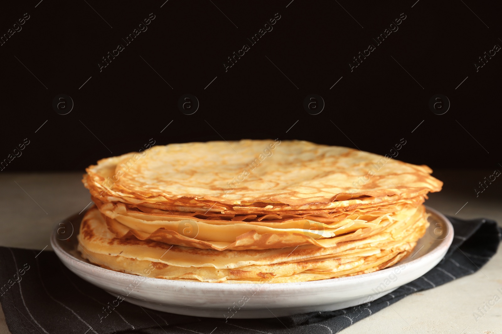 Photo of Stack of fresh thin pancakes on table