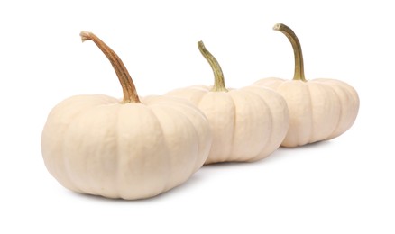 Photo of Three ripe beige pumpkins isolated on white