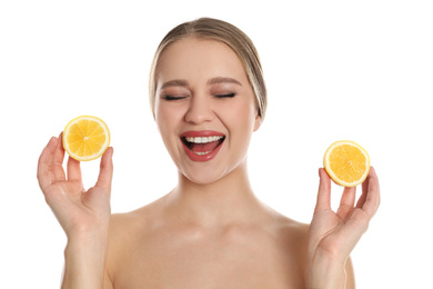 Emotional young woman with cut lemon on white background. Vitamin rich food