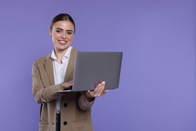 Happy woman with laptop on violet background. Space for text