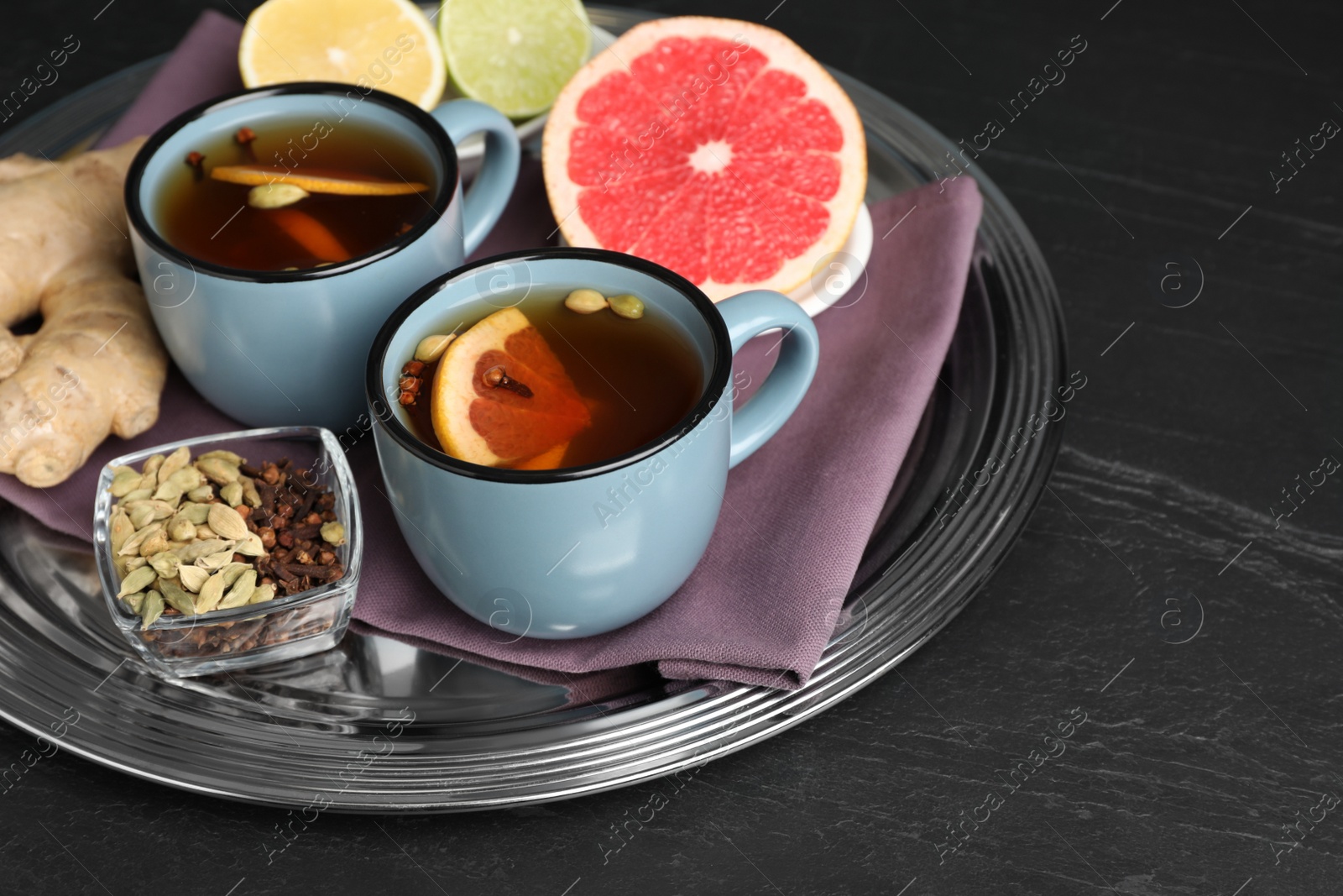 Photo of Immunity boosting drink and ingredients on black table