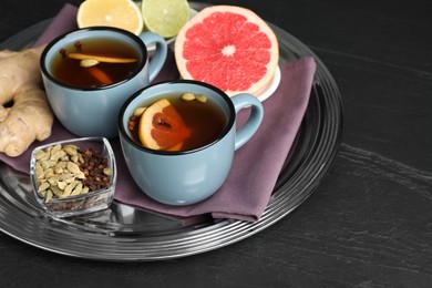 Photo of Immunity boosting drink and ingredients on black table