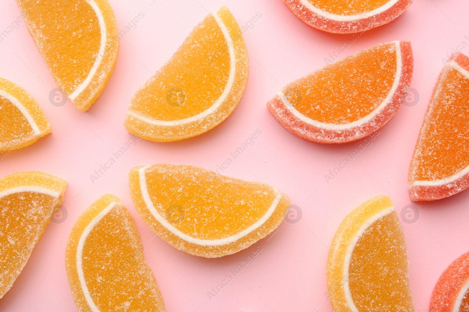Photo of Flat lay composition with bright tasty jelly candies on color background