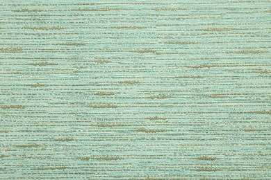 Image of Pale green wallpaper sheet as background, top view