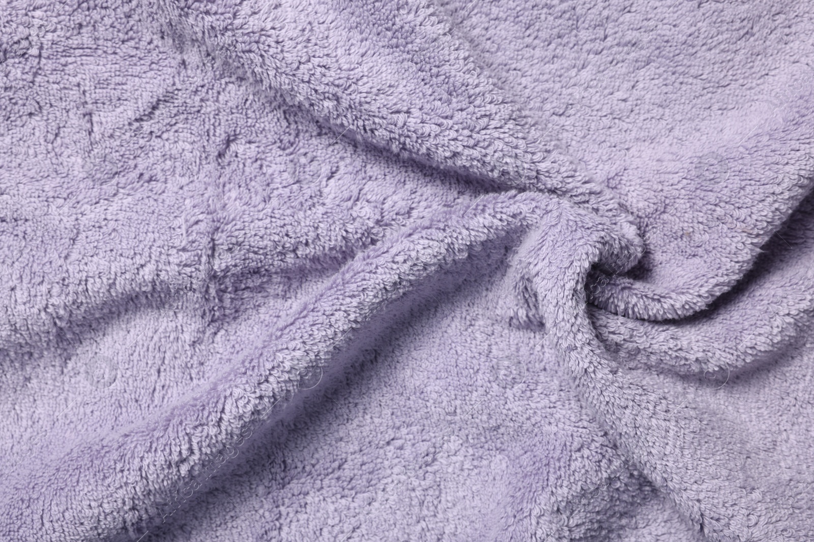 Photo of Texture of soft violet crumpled fabric as background, top view