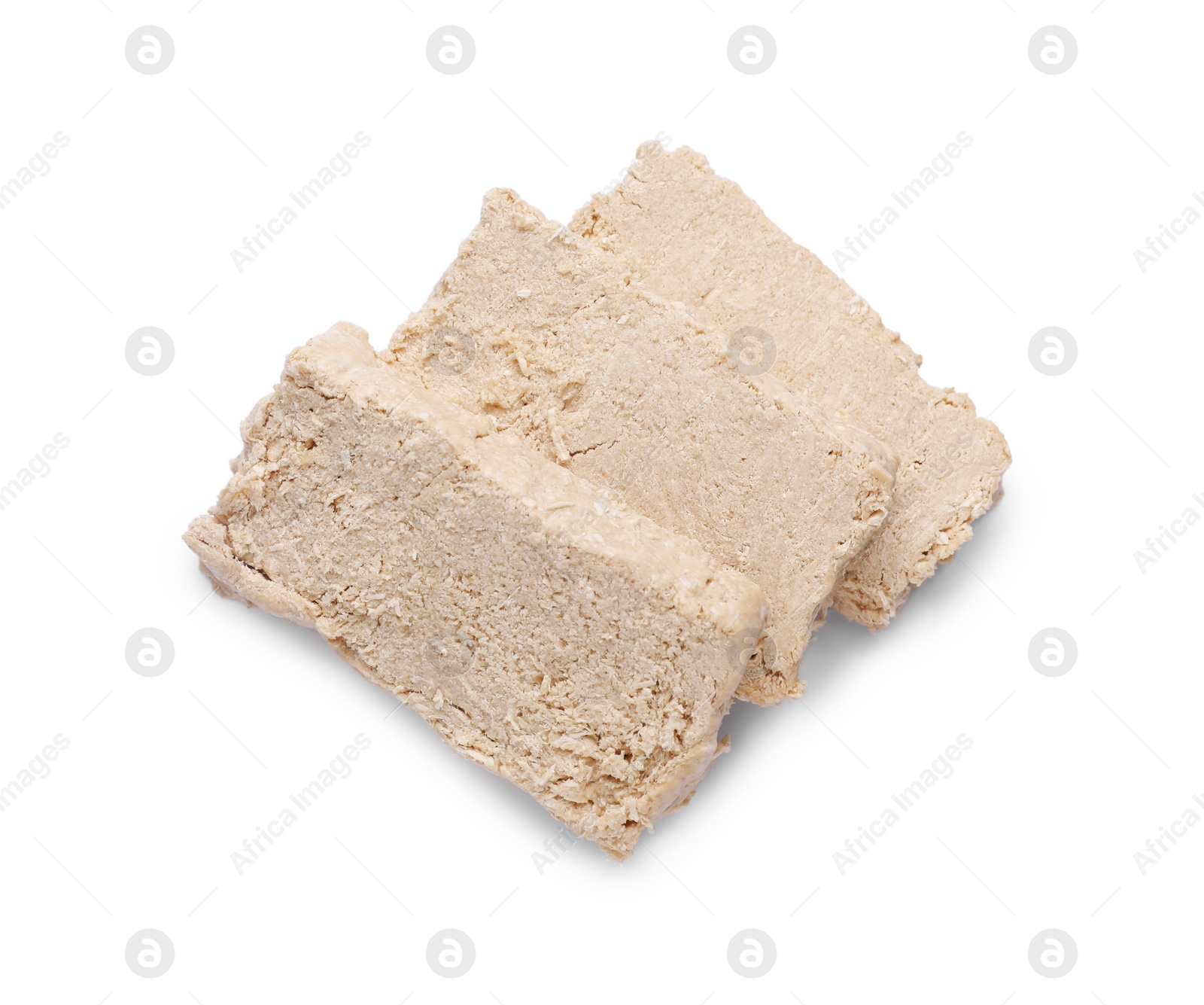 Photo of Pieces of tasty halva isolated on white, top view