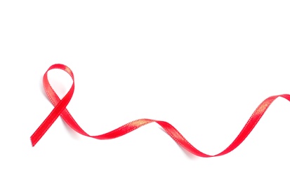 Photo of Red ribbon on white background, top view. Cancer awareness