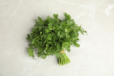 Photo of Bunch of fresh green parsley on light background, view from above
