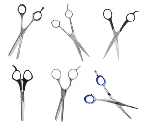 Set of different professional hairdresser scissors on white background 