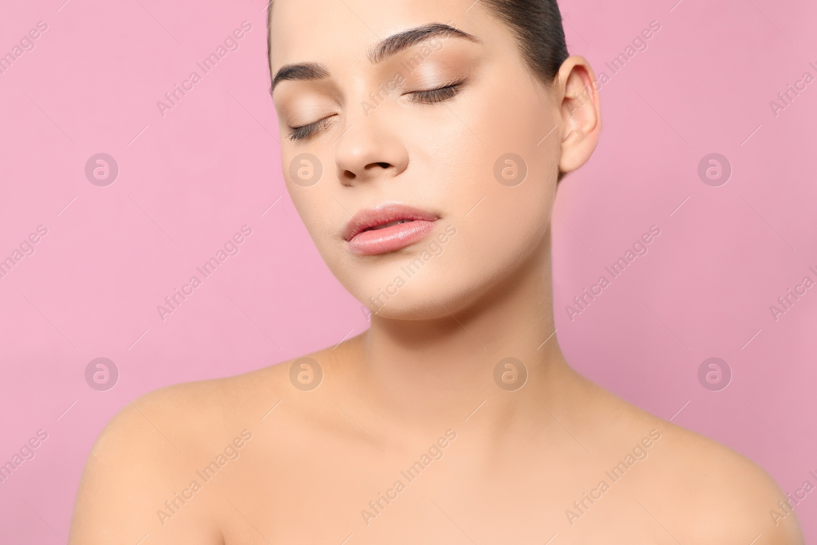 Photo of Portrait of young woman with beautiful face and natural makeup on color background, closeup