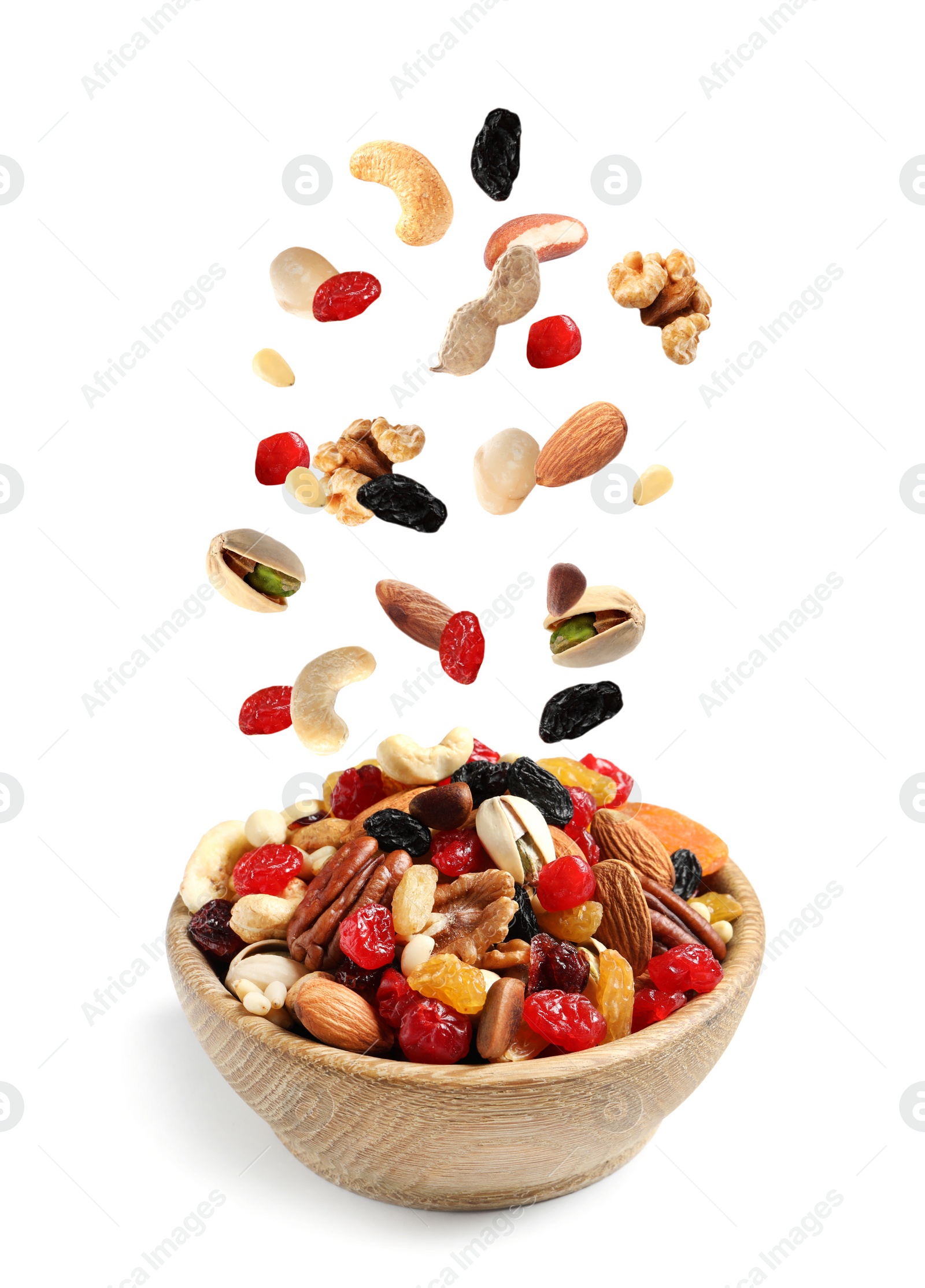 Image of Different nuts falling into bowl on white background 