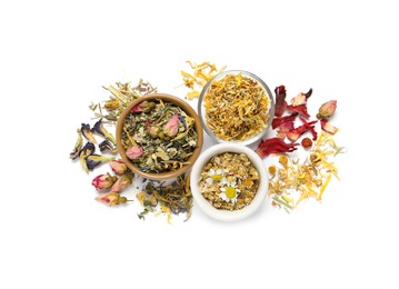 Different dry herbal teas on white background, top view