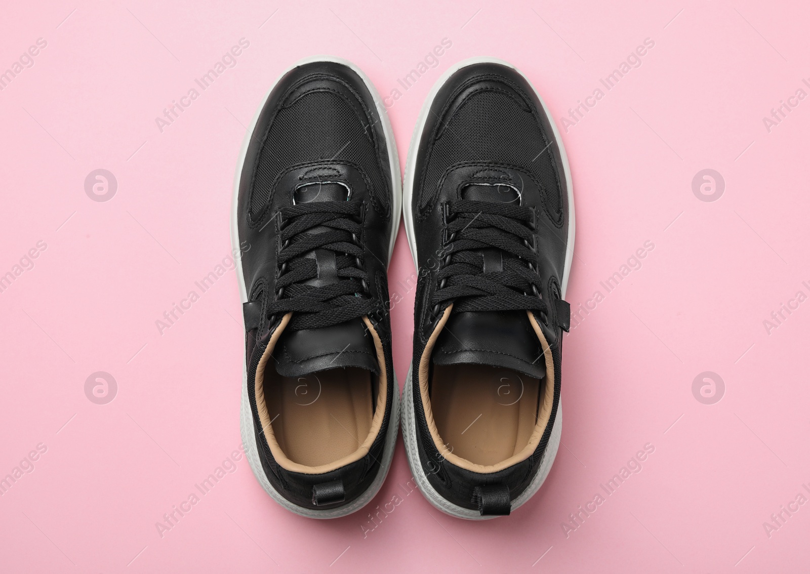 Photo of Pair of stylish shoes on pink background, top view