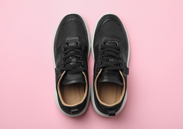 Photo of Pair of stylish shoes on pink background, top view