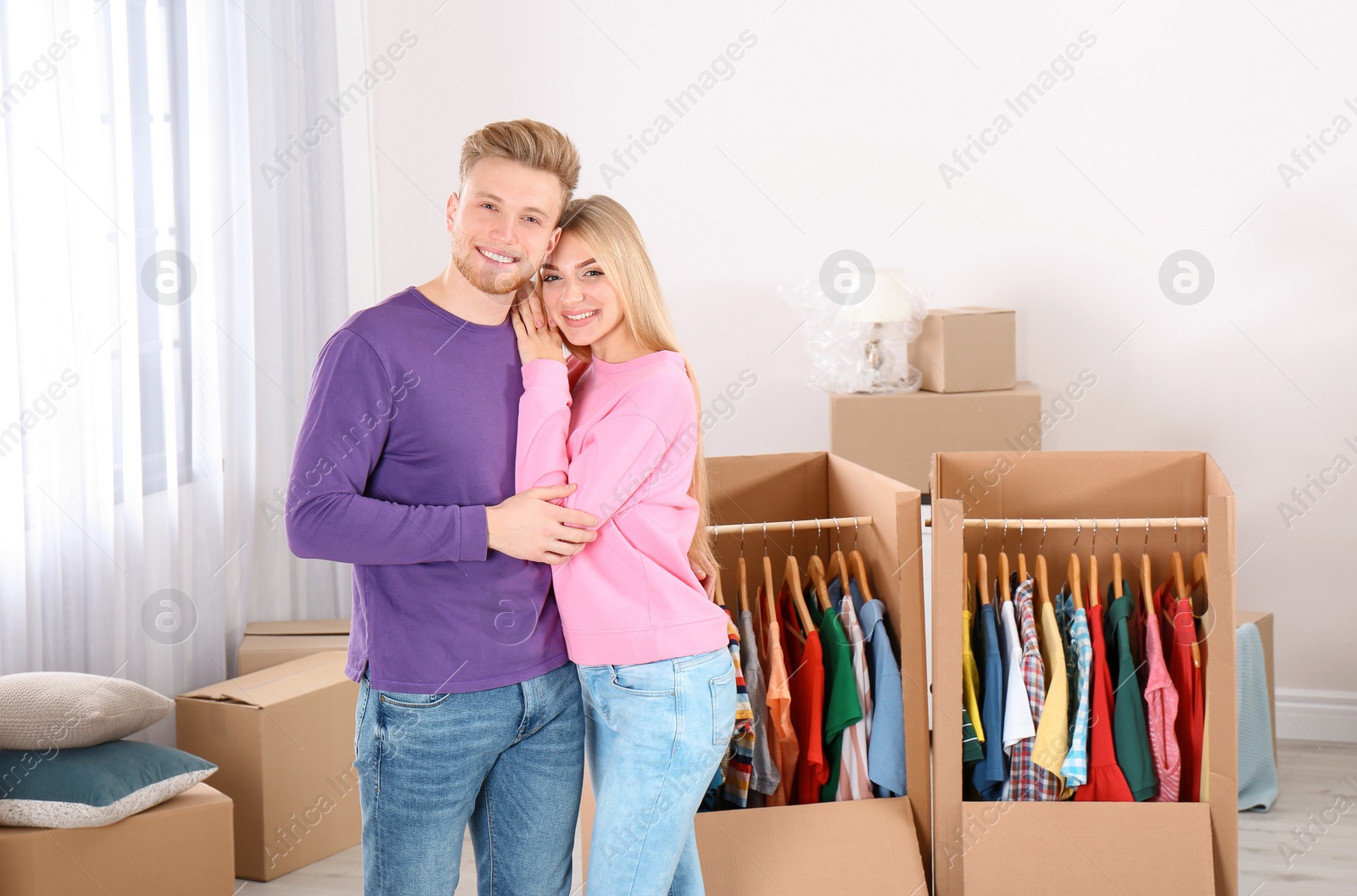 Photo of Young couple near wardrobe boxes at home