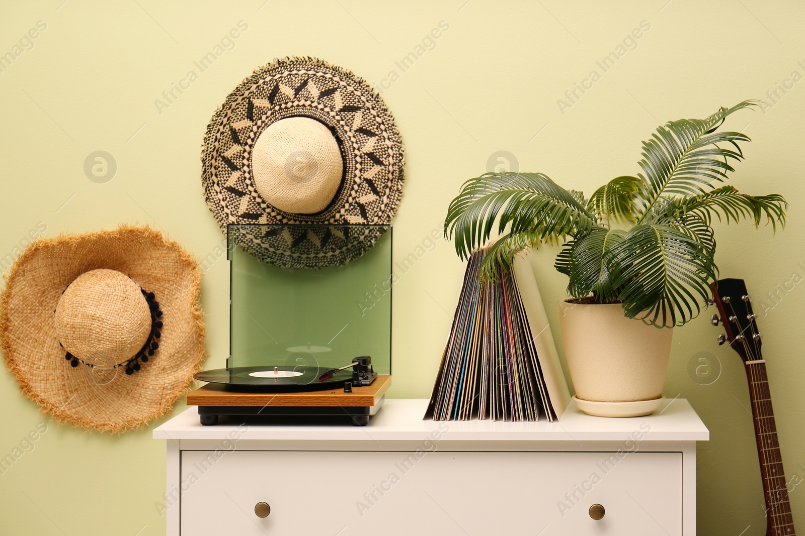 Photo of Stylish room interior with turntable and collection of vinyl records