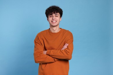 Photo of Portrait of handsome young man on light blue background