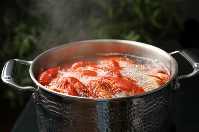 Fresh delicious crayfishes in boiling water closeup
