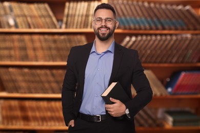 Image of Successful lawyer in glasses against shelves with books