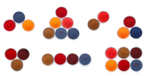 Set of different powdered food coloring in bowls isolated on white, top view