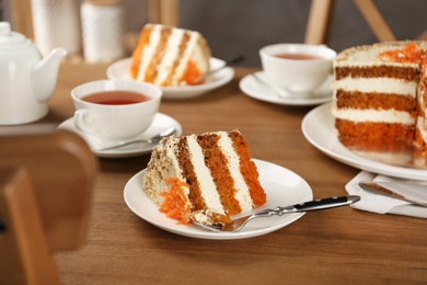 Photo of Tasty carrot cake served on wooden table