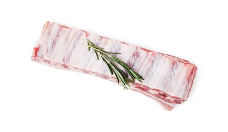 Photo of Raw pork ribs with rosemary isolated on white, top view