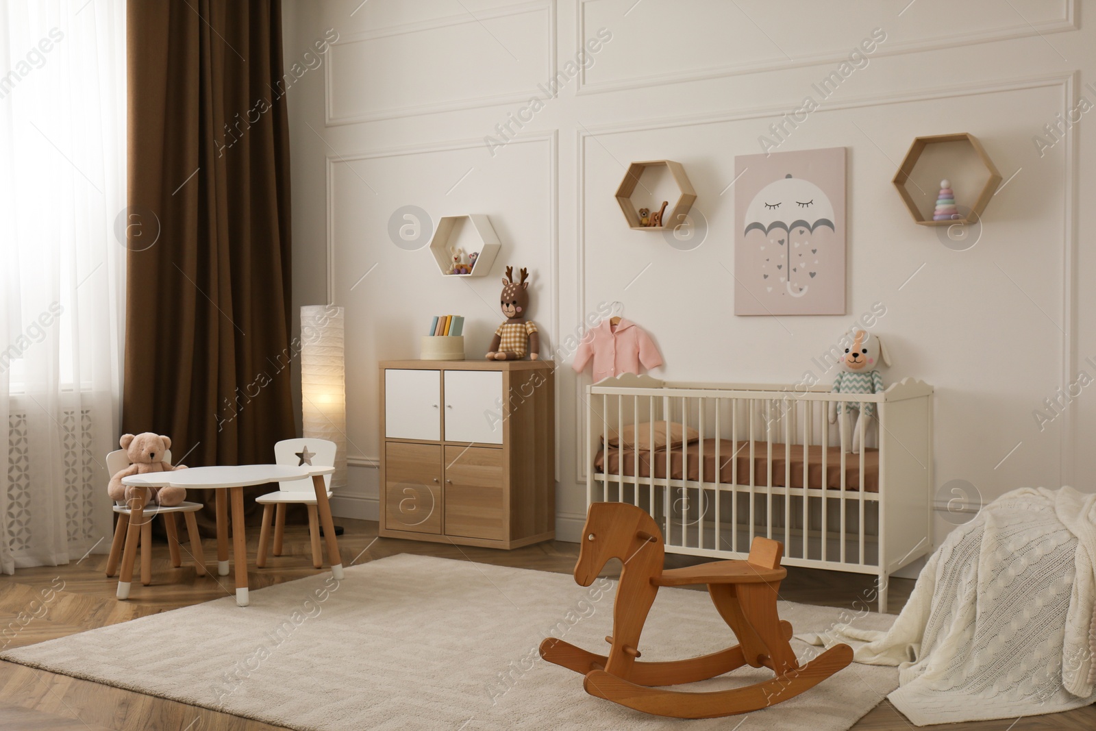 Photo of Modern baby room interior with stylish furniture and toys