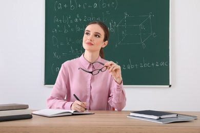 Portrait of young female teacher in classroom