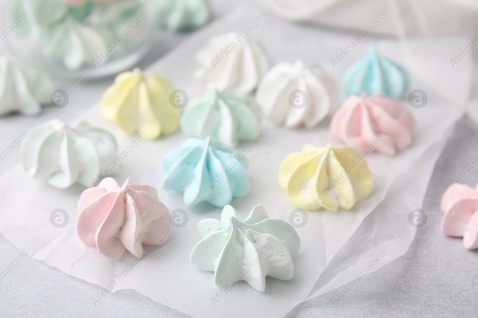 Photo of Tasty meringue cookies on light grey table, closeup