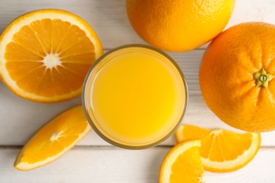 Photo of Flat lay composition with orange juice and fresh fruit on wooden background