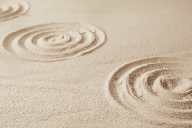 Photo of Zen garden pattern on sand. Meditation and harmony