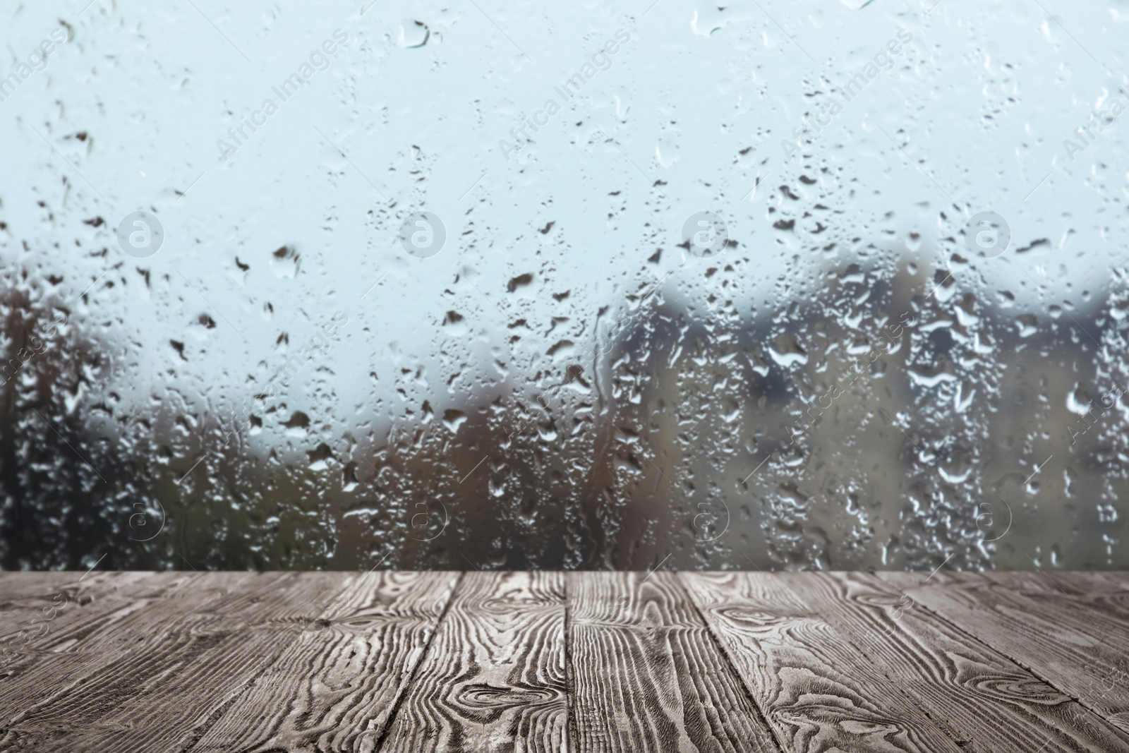 Image of Wooden table near window on rainy day