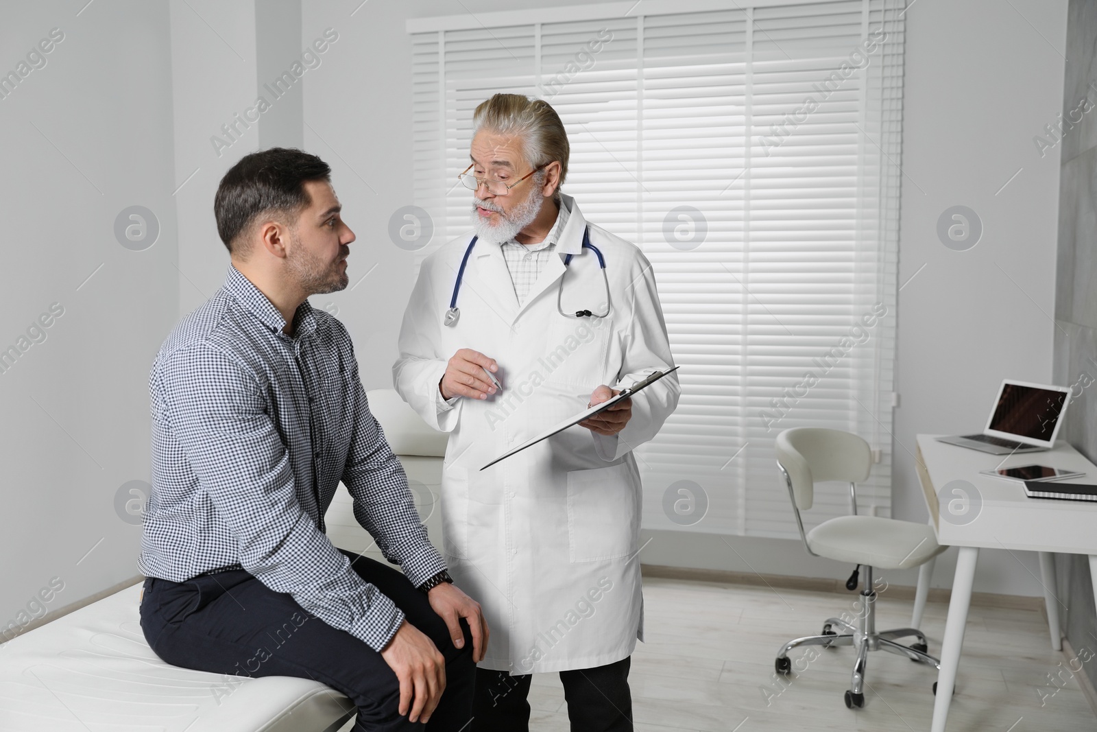 Photo of Patient having appointment with senior doctor in clinic