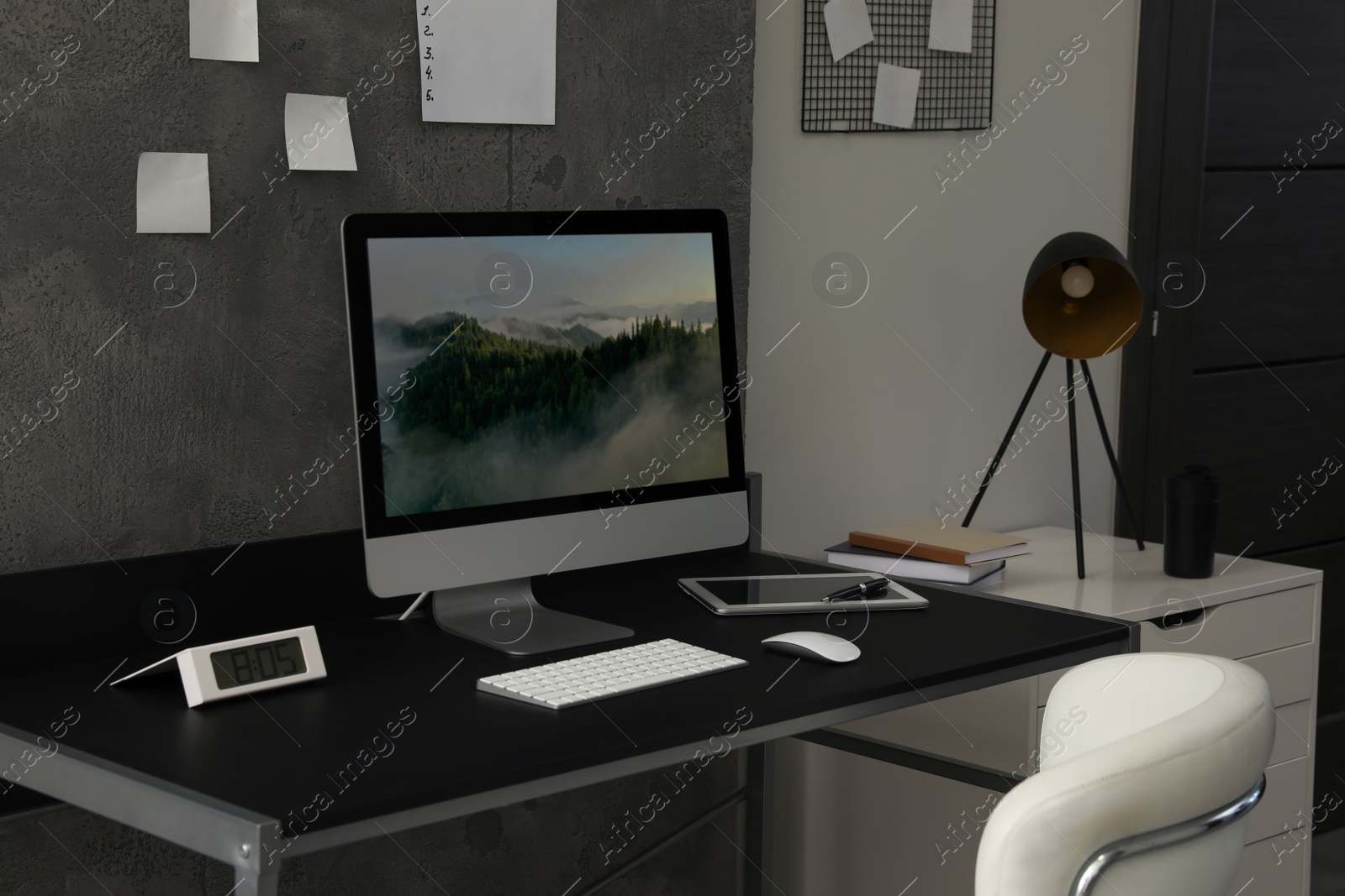 Photo of Stylish room interior with comfortable workplace near grey wall