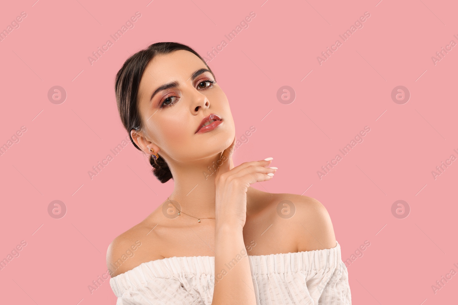 Photo of Beautiful woman with elegant jewelry on pink background